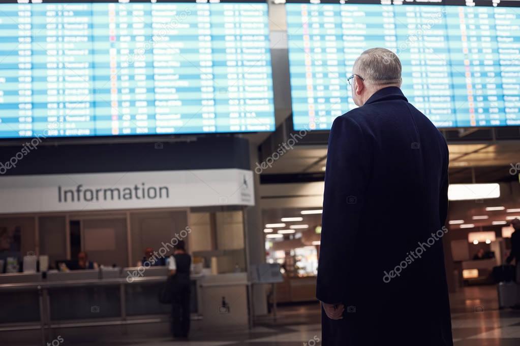 Man near airline schedule