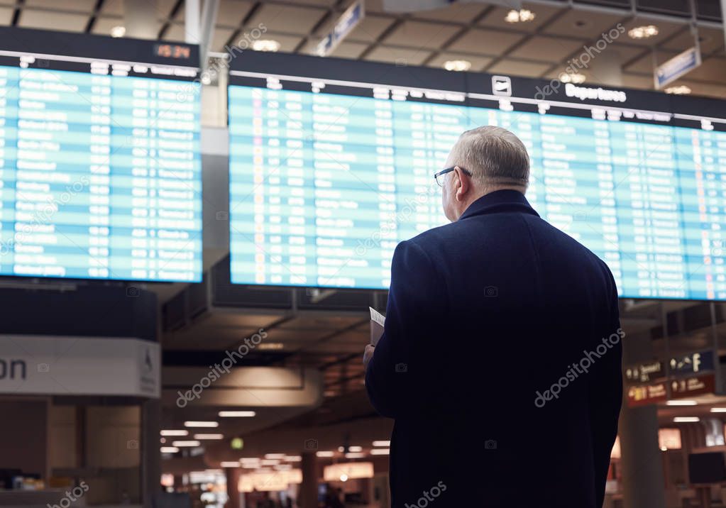 Man near airline schedule