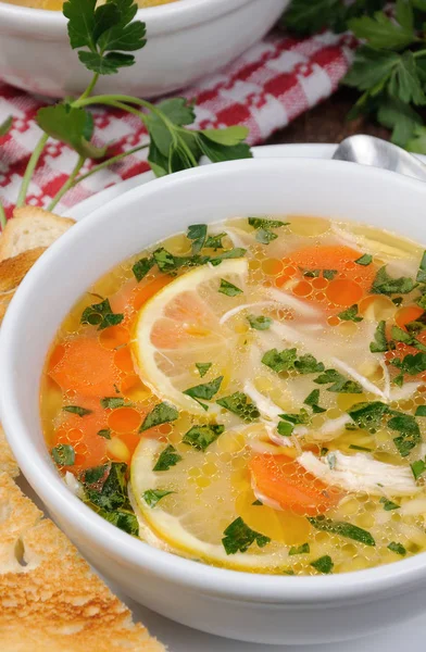Homemade, tender soup with chicken, lemon, orzo, and fresh parsley leaves — Stock Photo, Image