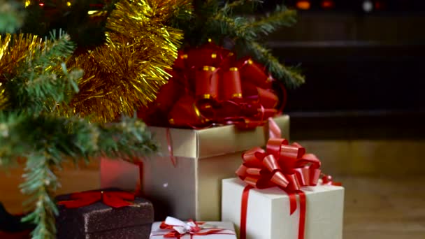 Decorated christmas tree with lights in front of fireplace — Stock Video