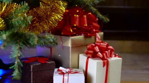 Decorated christmas tree with lights in front of fireplace — Stock Video