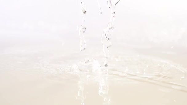 Fresh tomato with water on white surface — Stock Video