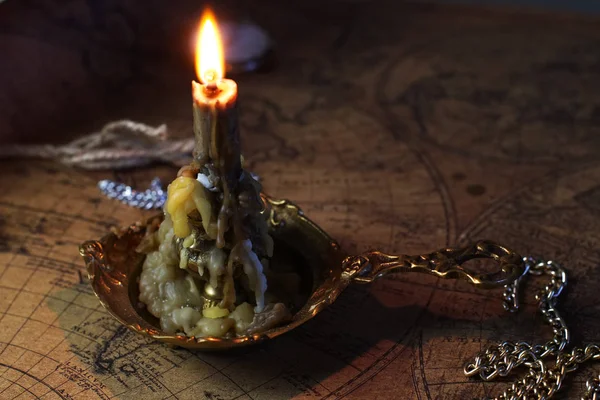 stock image candle lie on old ancient map