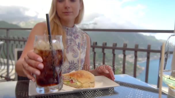 Young blonde woman with cola in restaurant at Ravello — Stock Video