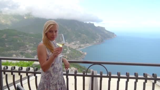 Young blonde woman with wine in restaurant at Ravello — Stock Video