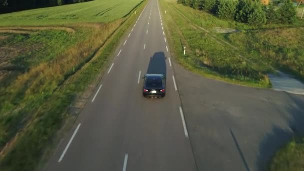 Vista aérea del coche deportivo conduciendo en campos — Vídeos de Stock