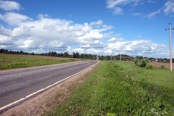 Country landscape with road of poor quality — Stock Photo, Image