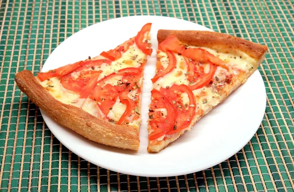 Аппетитные кусочки пиццы на тарелке крупным планом — стоковое фото
