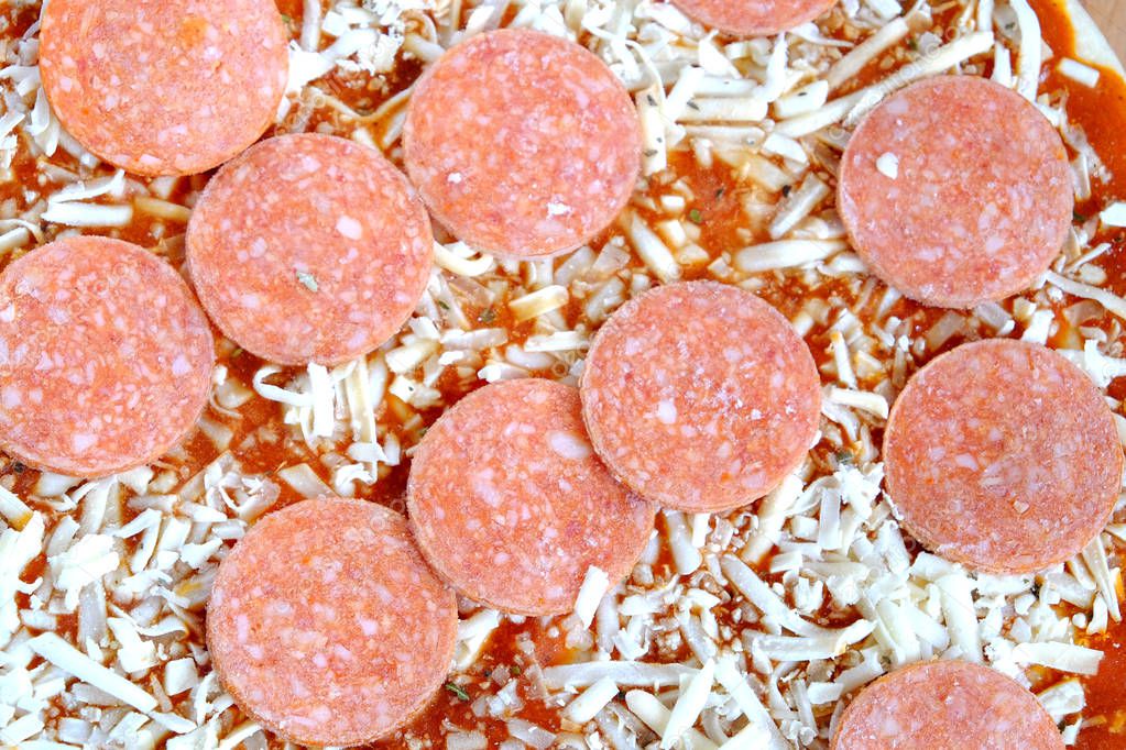 Raw unprepared pizza as background close-up