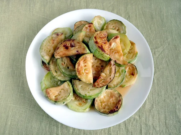Fried zucchini slices on white plate — Stock Photo, Image