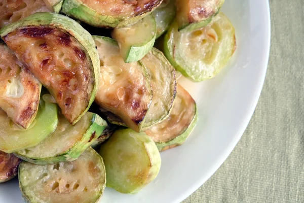 Fried zucchini slices on white plate — Stock Photo, Image