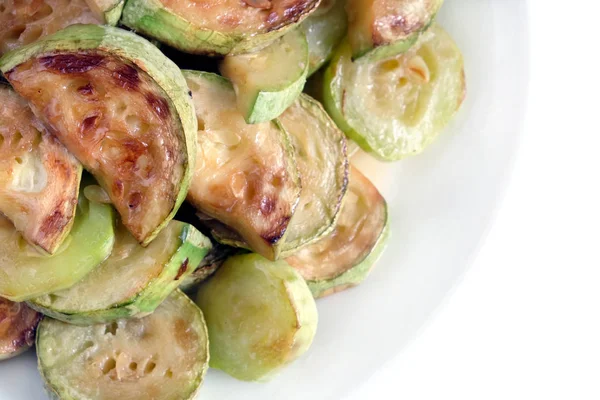 Fried zucchini slices on white plate isolated — Stock Photo, Image