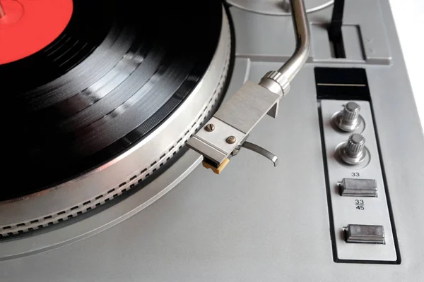 Turntable in silver case with vinyl record with red label isolated on white background. top — Stock Photo, Image