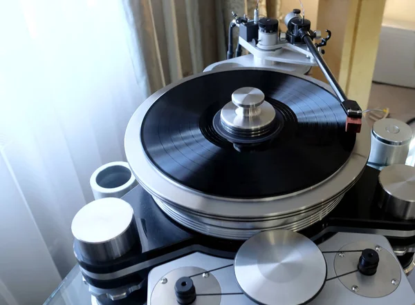 Modern high-precision High End record player with a rotating disc with an installed vinyl record in the interior