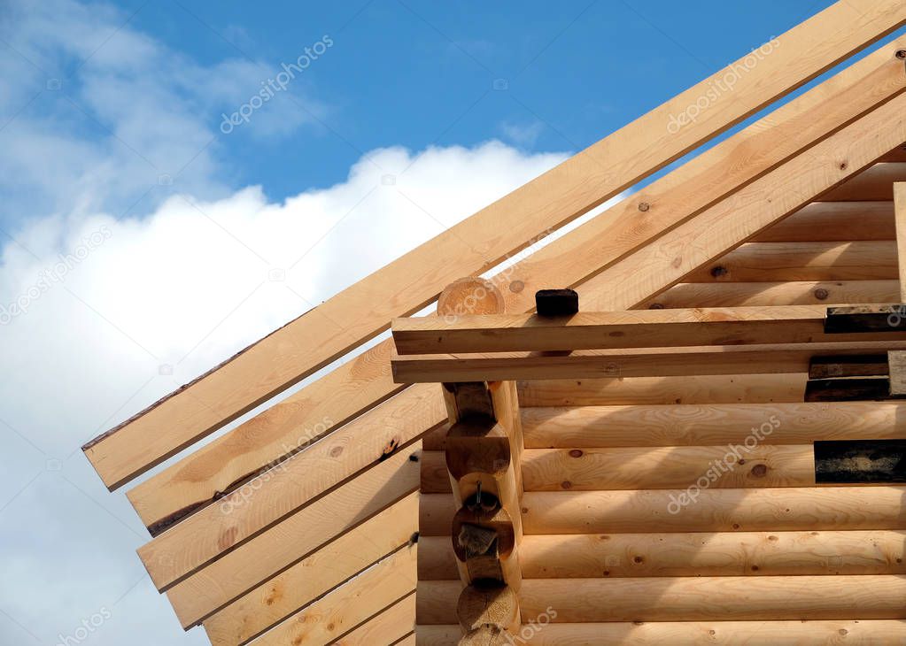 Process of wooden house straight roof slope mounting front view. Wooden country house construction