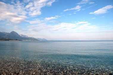 Seascape with calm transparent clear water near sea coast on resort place on sunny day