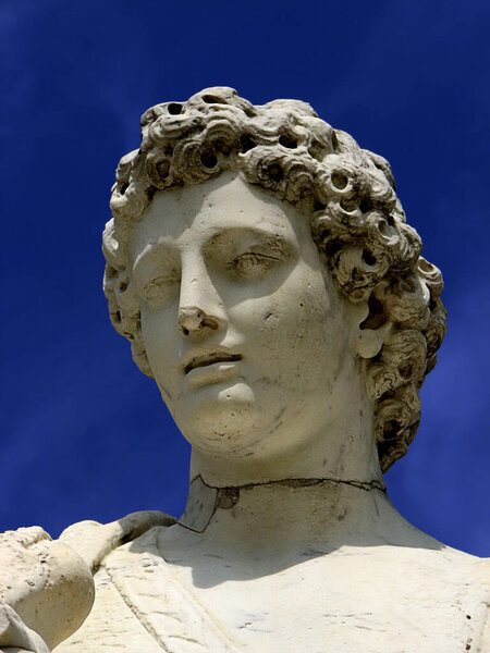 Statue of a young man in Versailles Gardens in France