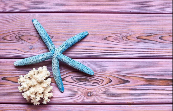 Starfish on a wooden purple background.