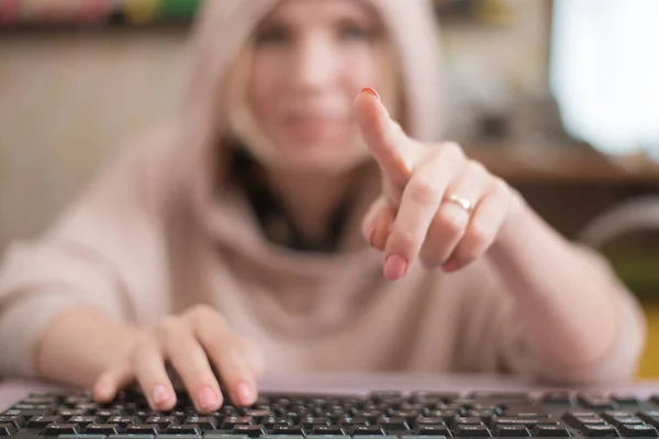 A woman draws a finger in the air like on a computer monitor. View from the side of the screen. The template for the inscriptions.