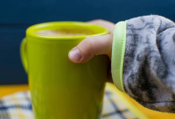 Mão Criança Toma Uma Xícara Verde Com Uma Bebida Cacau — Fotografia de Stock