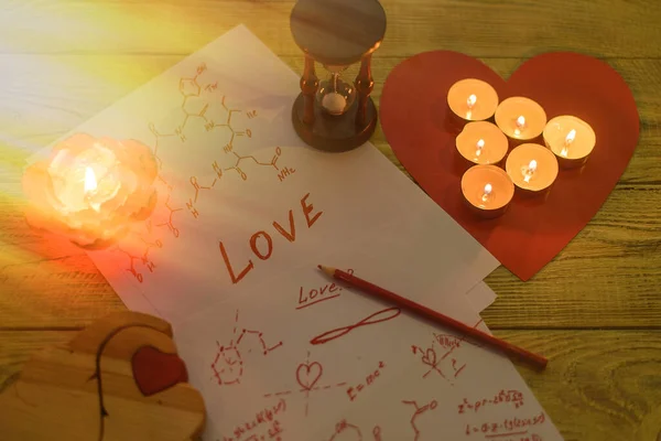 Formula love concept. Research, search for an answer to the question: what is love. Sheets of paper with chemical formulas of hormones by candlelight.