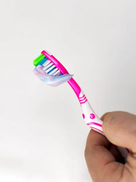 Toothbrush Squeezed Toothpaste Her Hand White Background — Stock Photo, Image