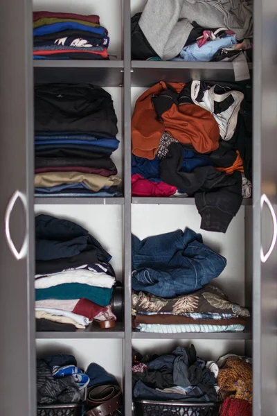 Shelves closet with folded things. Maintain order in the closet.