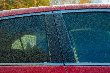 Kış ayazındaki kırmızı arabanın bir parçası.