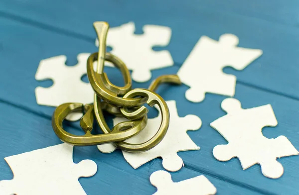 Jigsaw puzzles which lies on a wooden background.