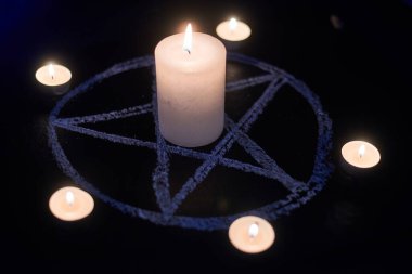 Pentagram ve yanan mumlar. Satanizmin sihirli ayini, ruhların yakarışı, ruhsal oturumlar..