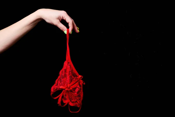 Erotisch Rood Slipje Een Vrouwelijke Hand Een Zwarte Achtergrond — Stockfoto