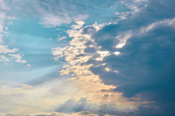 Sun rays breaking through the dark clouds 