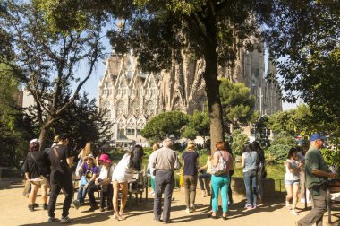 Tourists at Nativity facade of La Sagrada Familia - the impressi clipart