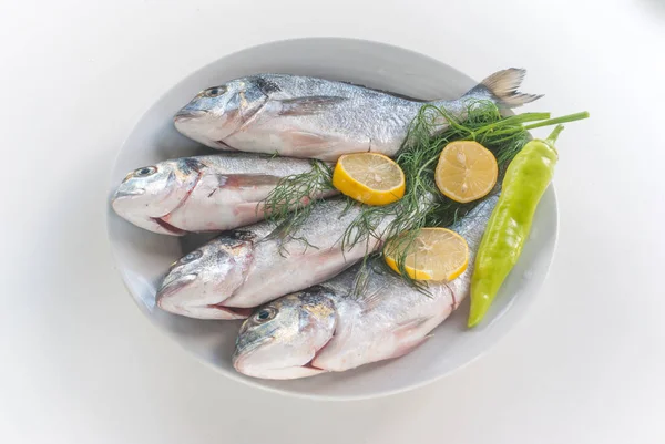 Peixes frescos com legumes e limão — Fotografia de Stock