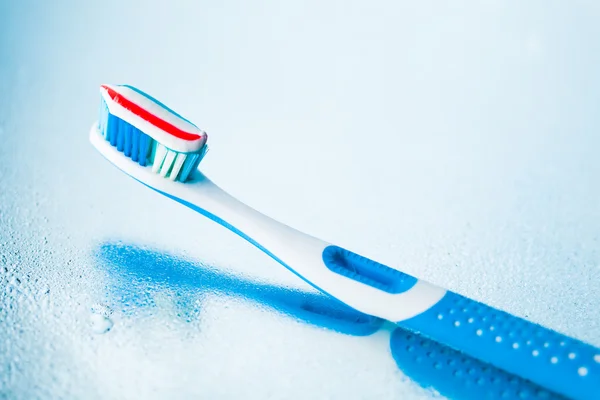 Toothbrush with red stripe toothpaste — Stock Photo, Image