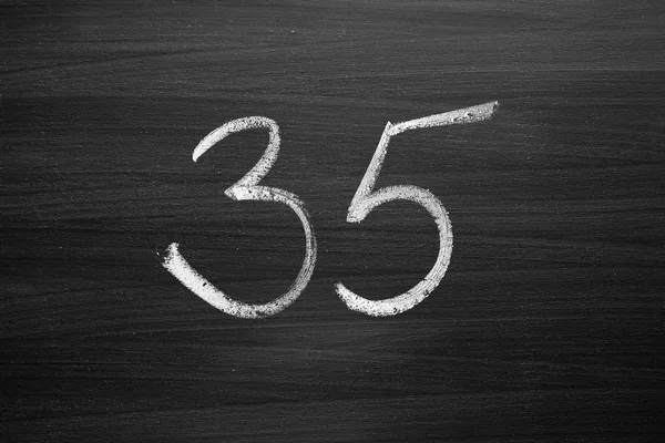 Number thirty five enumeration written with a chalk on the blackboard — ストック写真
