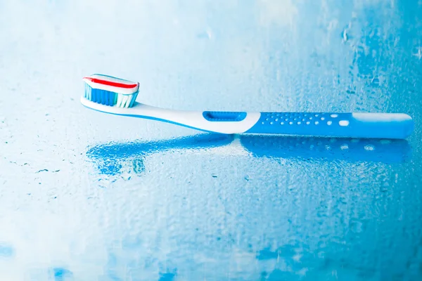 Toothbrush with red stripe toothpaste — Stock Photo, Image