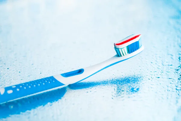 Toothbrush with red stripe toothpaste — Stock Photo, Image