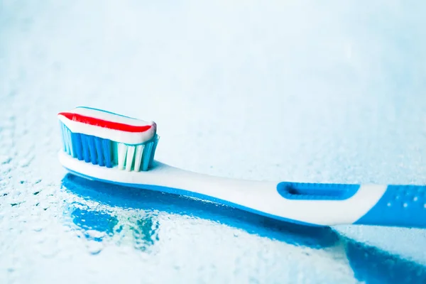 Toothbrush with red stripe toothpaste — Stock Photo, Image