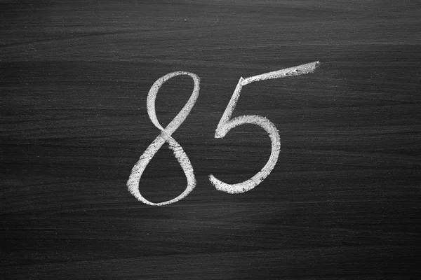 Number eighty five enumeration written with a chalk on the blackboard — Stock Photo, Image
