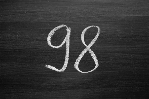 Number ninety eight enumeration written with a chalk on the blackboard — Stock Photo, Image