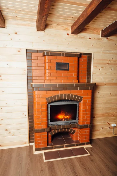 Brick fireplace in wooden house — Stock Photo, Image