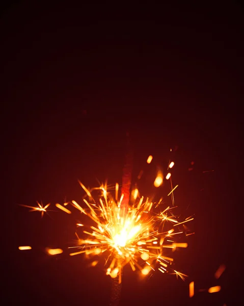 Christmas sparkler in haze with red light — Stock Photo, Image