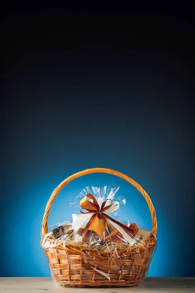 Gift basket on blue background with copy-space — Stock Photo, Image