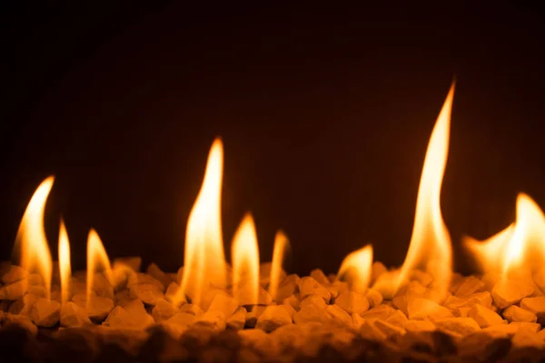 Gas fireplace with pebble crushed stones — Stock Photo, Image