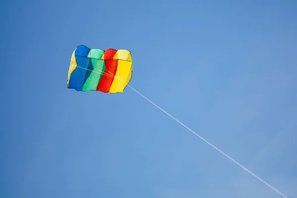 Colorful kite on blue sky background — Stock Photo, Image