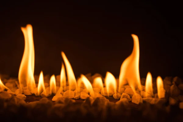 Gas fireplace with pebble crushed stones — Stock Photo, Image