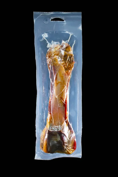 Beef bone in vacuum bag, treat for dog — Stock Photo, Image