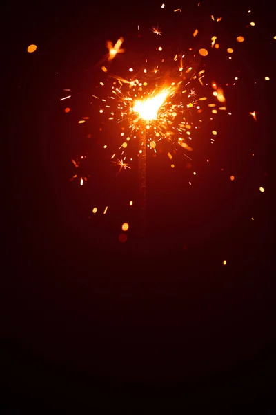 Christmas sparkler in haze with red light — Stock Photo, Image