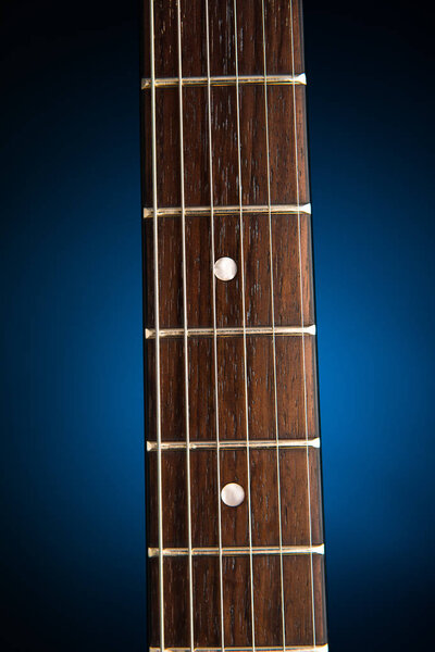 Electric guitar neck, blue background